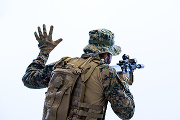 Image showing soldier in action giving comands to team by hand sign