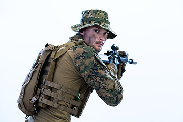 Image showing soldier in action aiming laseer sight optics