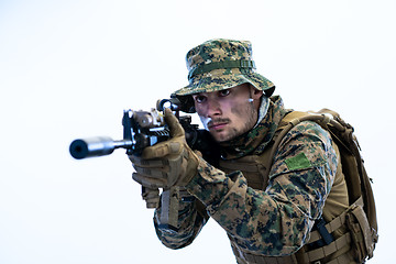 Image showing soldier in action aiming laseer sight optics