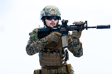 Image showing soldier in action aiming laseer sight optics