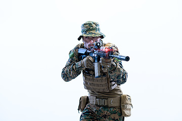 Image showing soldier in action aiming laseer sight optics