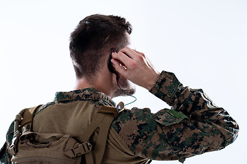 Image showing soldier preparing gear for action and checking communication