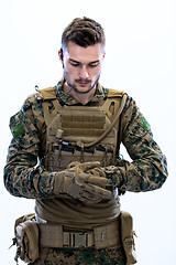 Image showing closeup of soldier hands putting protective battle gloves