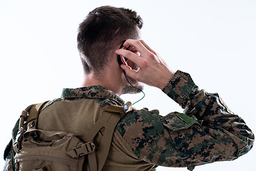 Image showing soldier preparing gear for action and checking communication