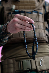 Image showing soldier praying tespih