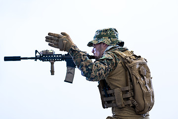 Image showing soldier in action aiming laseer sight optics