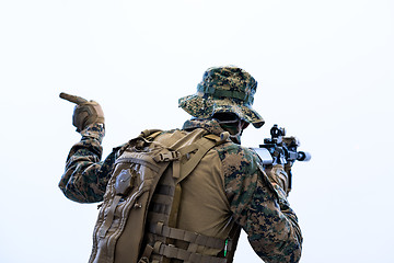 Image showing soldier in action giving comands to team by hand sign