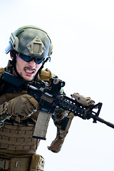 Image showing soldier in action aiming laseer sight optics