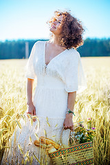 Image showing beautiful middle-aged woman in a white dress in a field