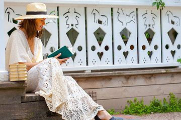 Image showing beautiful middle-aged woman in a straw hat and in a white dress