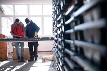 Image showing team of mining  workers measuring drilled rock core