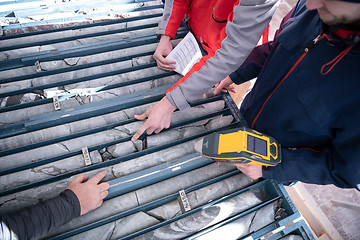 Image showing team of mining  workers measuring drilled rock core