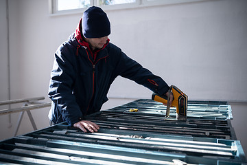 Image showing team of mining  workers measuring drilled rock core