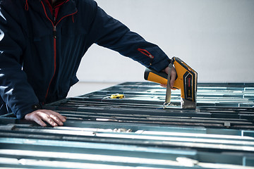 Image showing team of mining  workers measuring drilled rock core