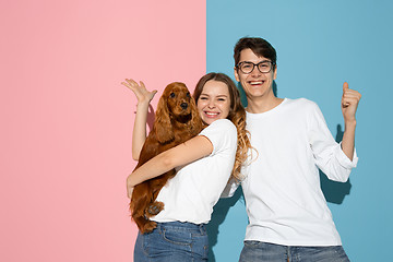 Image showing Young emotional man and woman on pink and blue background