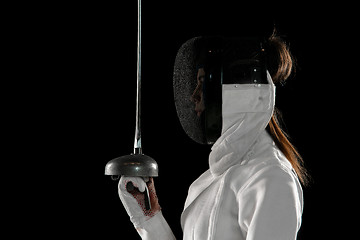 Image showing Teen girl in fencing costume with sword in hand isolated on black background