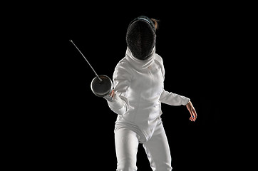 Image showing Teen girl in fencing costume with sword in hand isolated on black background