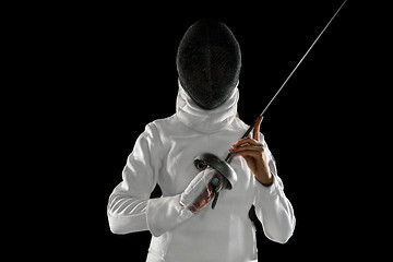 Image showing Teen girl in fencing costume with sword in hand isolated on black background