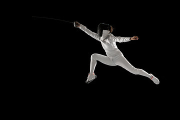 Image showing Teen girl in fencing costume with sword in hand isolated on black background