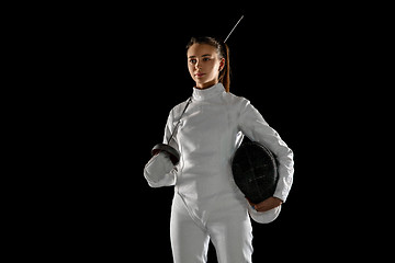 Image showing Teen girl in fencing costume with sword in hand isolated on black background