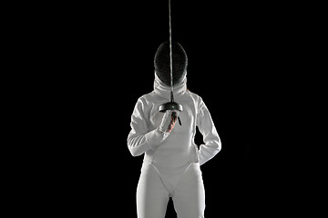 Image showing Teen girl in fencing costume with sword in hand isolated on black background