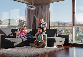 Image showing Happy family playing a video game