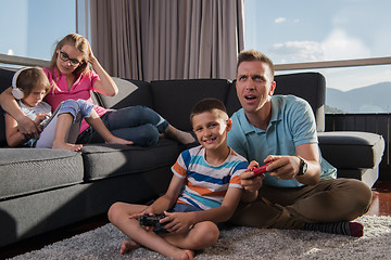 Image showing Happy family playing a video game