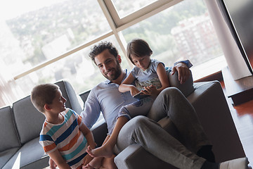 Image showing happy young father spending time with kids