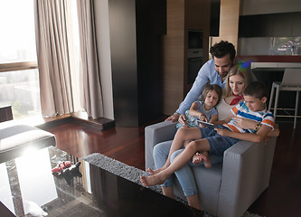 Image showing happy young couple spending time with kids