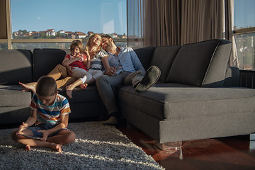 Image showing happy young couple spending time with kids at home