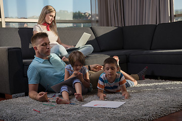 Image showing young couple spending time with kids at home