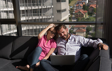 Image showing couple relaxing at  home using laptop computers