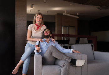 Image showing Young couple on the sofa watching television