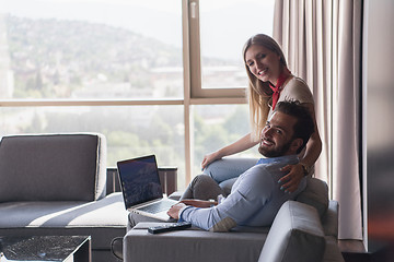 Image showing couple relaxing at  home using laptop computers