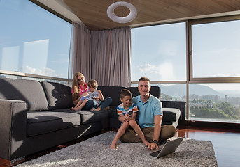 Image showing Happy family playing a video game