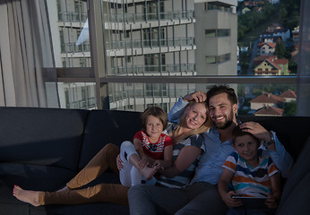 Image showing happy young couple spending time with kids at home