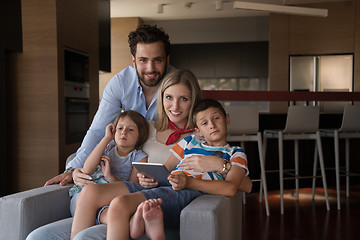 Image showing happy young couple spending time with kids