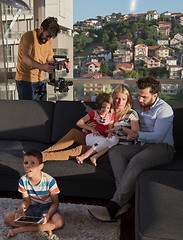 Image showing happy young couple spending time with kids at home