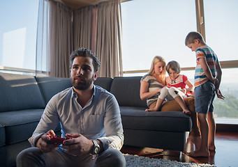 Image showing Happy family playing a video game