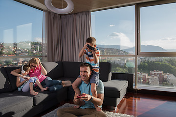 Image showing Happy family playing a video game