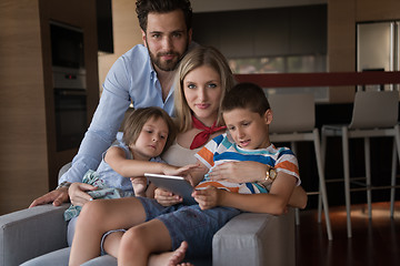 Image showing happy young couple spending time with kids