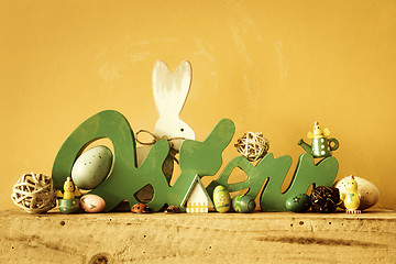 Image showing Word Easter in german language with easter bunny eggs and chicks