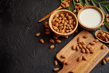 Image showing Close up of Almonds in wooden bowl and almond milk