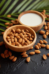 Image showing Close up of Almonds in wooden bowl and almond milk