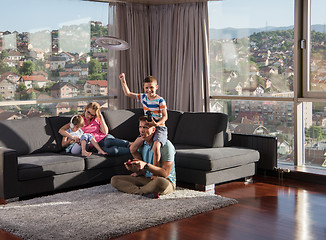 Image showing Happy family playing a video game