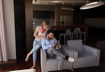 Image showing couple relaxing at  home with tablet computers