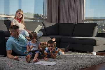 Image showing young couple spending time with kids at home