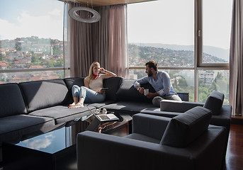 Image showing couple relaxing at  home using tablet computer