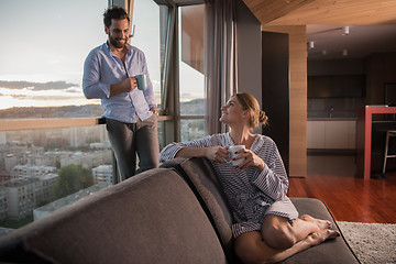 Image showing young couple enjoying evening coffee by the window