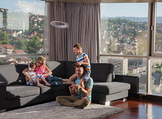 Image showing Happy family playing a video game